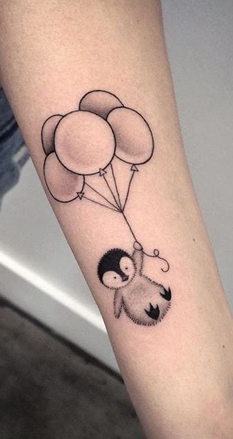 Penguin tattoo on the forearm for women