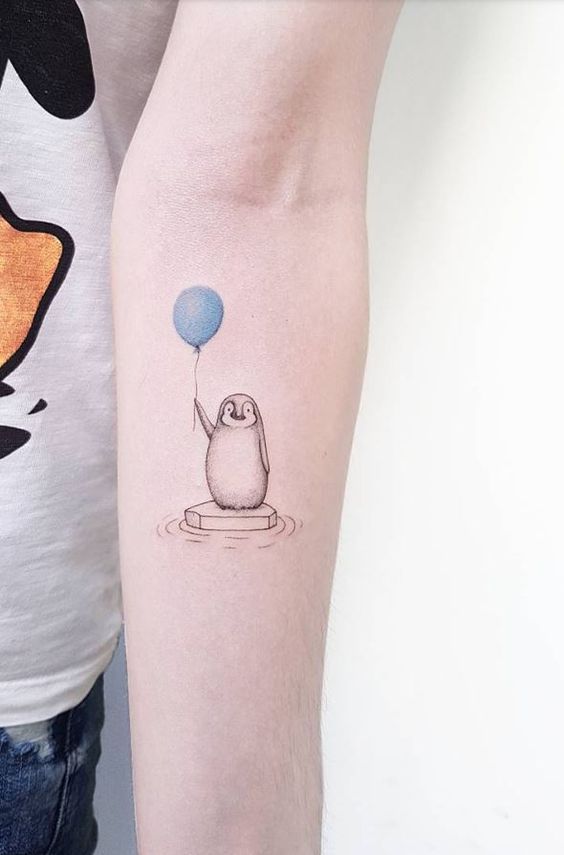 Tattoo of a penguin on the forearm for men