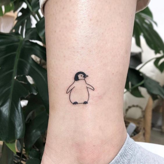 Penguin tattoo on the shin for women