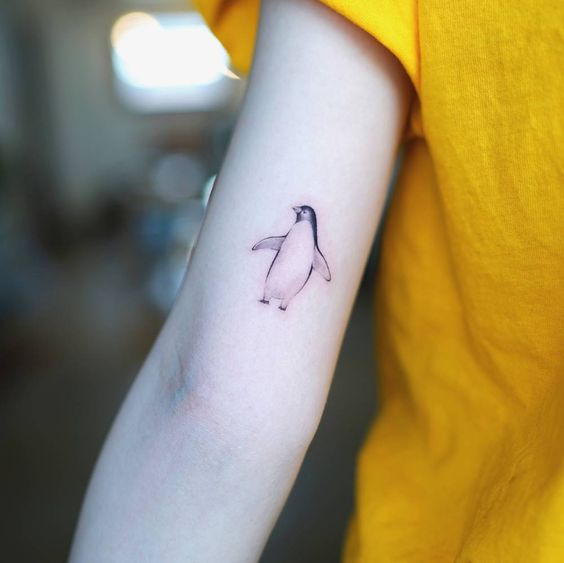 Penguin tattoo on the shoulder for women