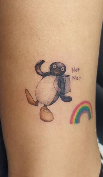 Tattoo of a penguin on the leg for women