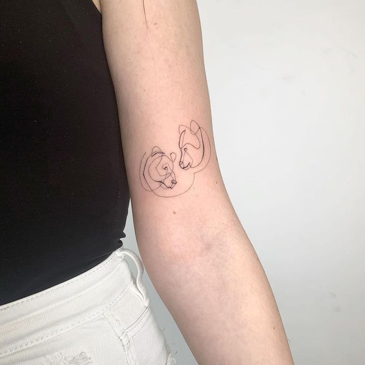 Tattoo of two bears on the shoulder for women