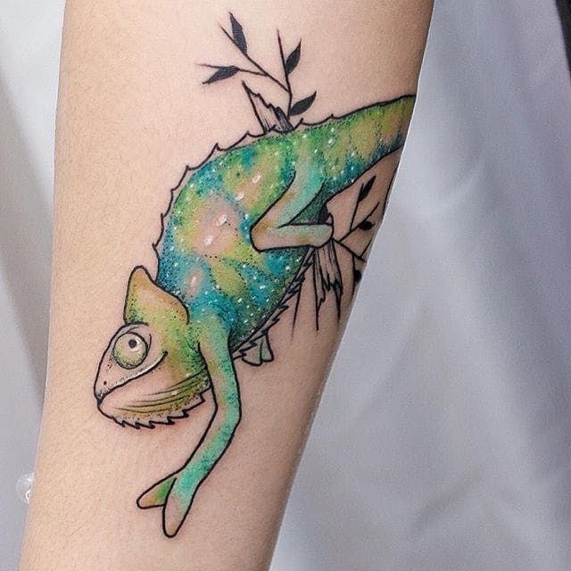 Tattoo of a colored chameleon on the arm for women