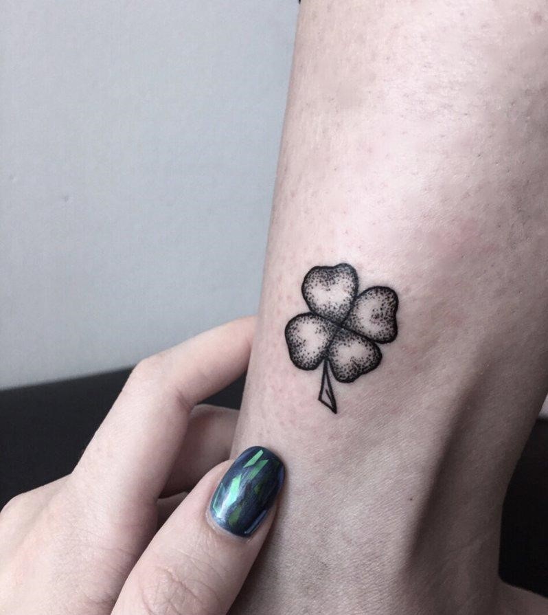 Tattoo of a clover on the arm for women