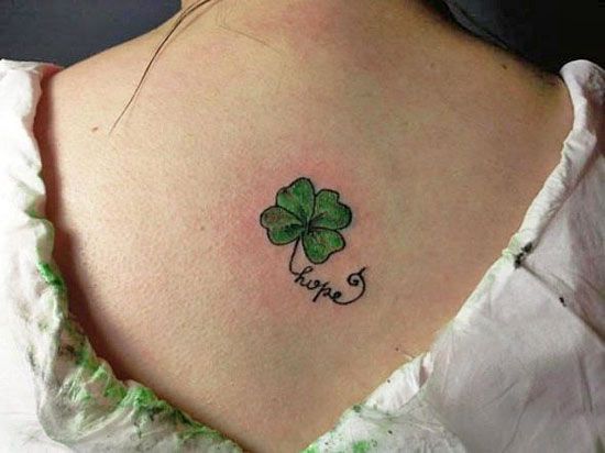 Colorful clover tattoo with inscription on the back for women