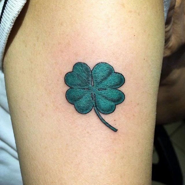 Colorful clover tattoo on the leg for women