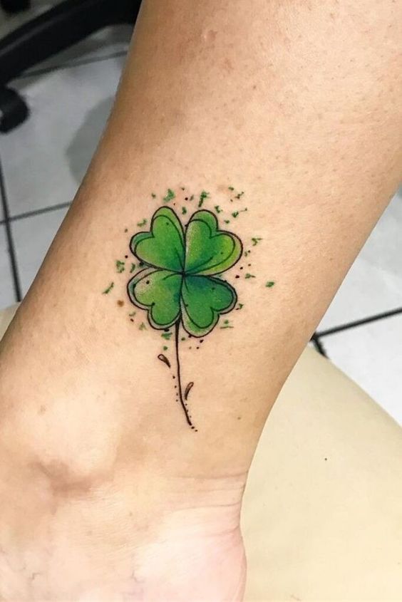 Color clover tattoo on the shin for women