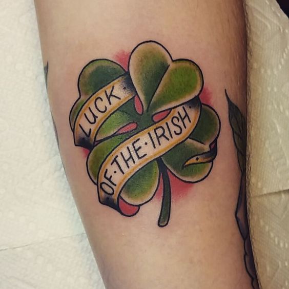 Colorful clover tattoo with inscription on the foot for women