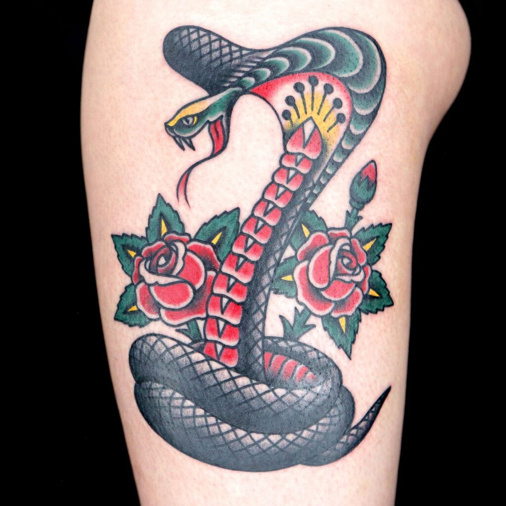 Tattoo of a colored cobra on the shoulder for men