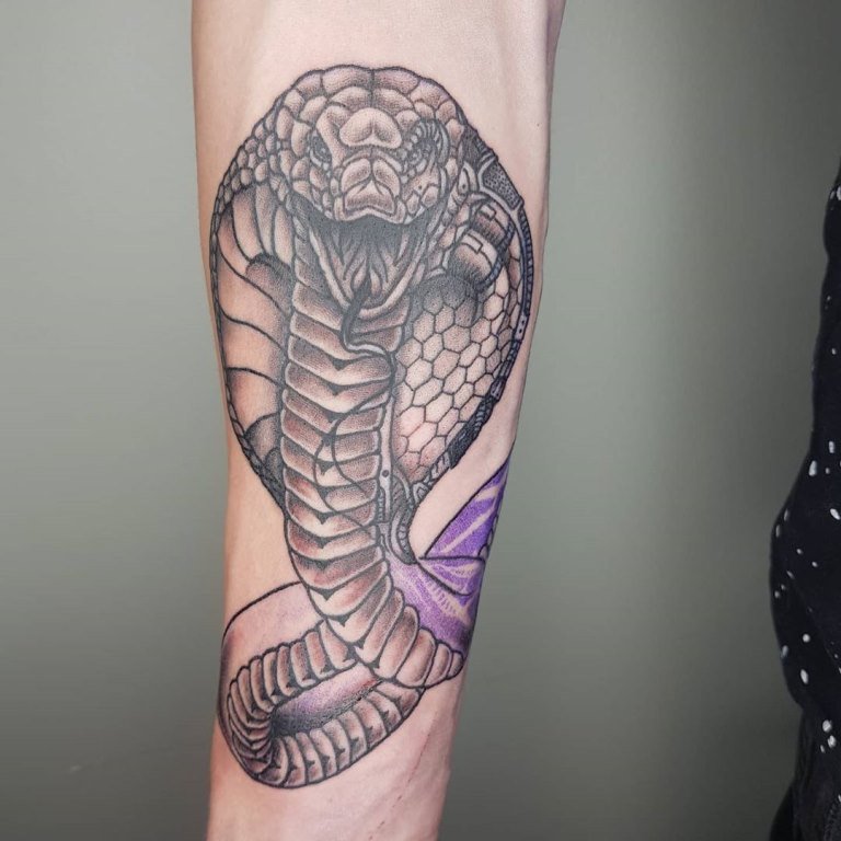 Large cobra tattoo on forearm for women Large cobra tattoo on forearm for women