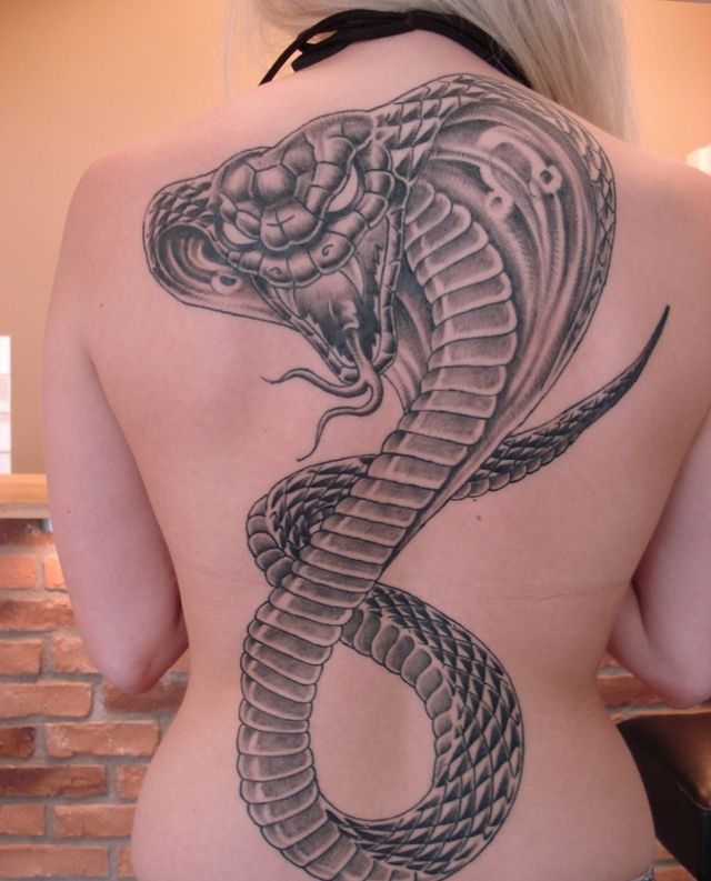 Large cobra tattoo on the back for women