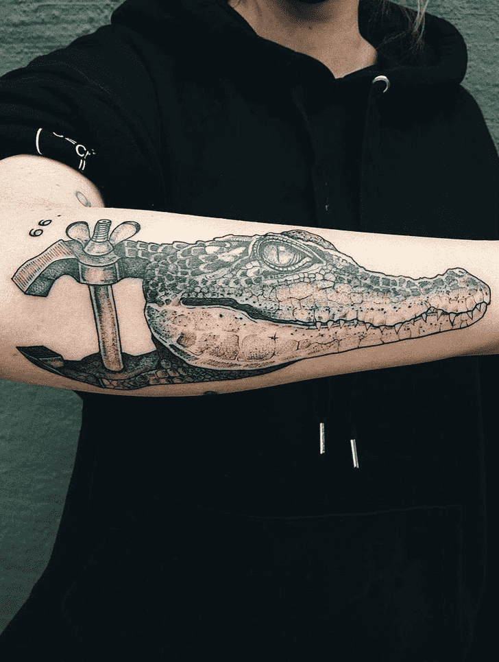 Tattoo of a crocodile on the forearm for men