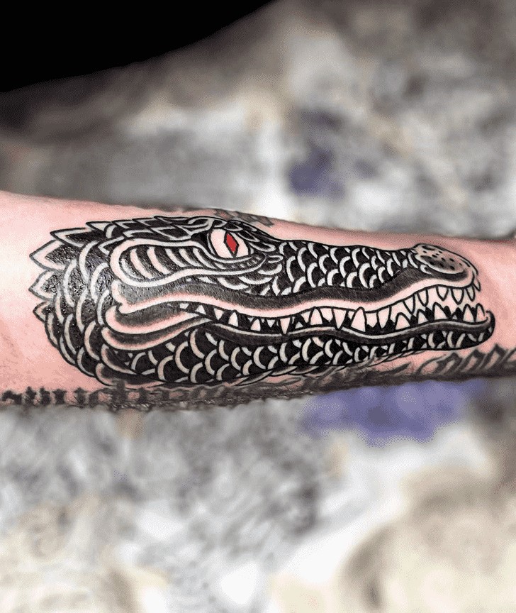 Tattoo of a crocodile on the forearm for men