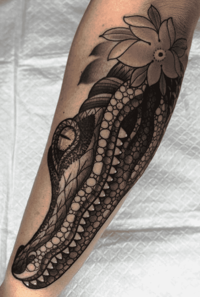 Tattoo of a crocodile on the forearm for men