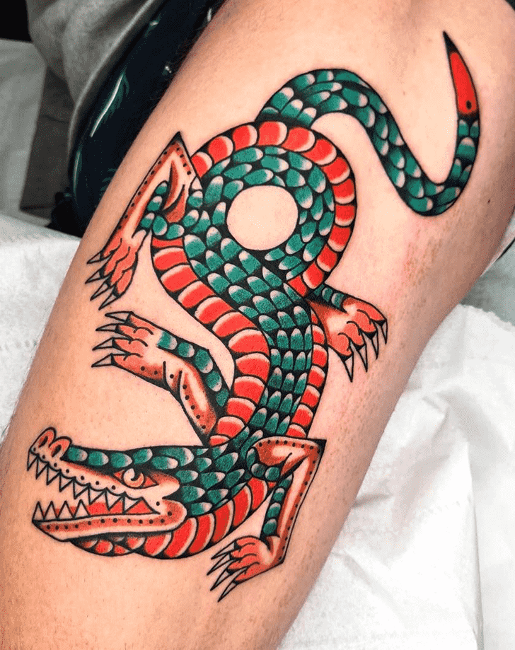 Tattoo of a colored crocodile on the thigh for men