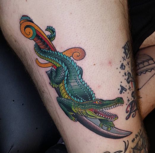 Tattoo of a colored crocodile on the thigh for men