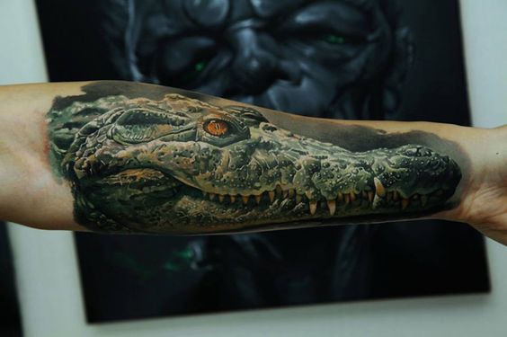 Large crocodile tattoo on the arm for men