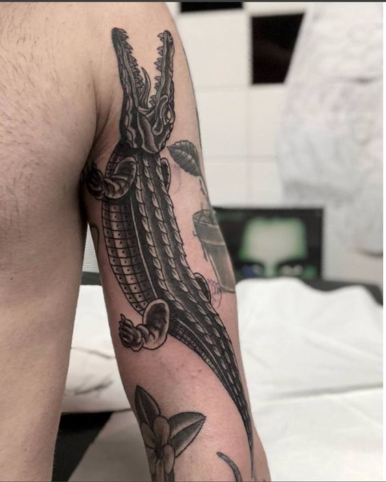 Tattoo of a crocodile on the shoulder for men