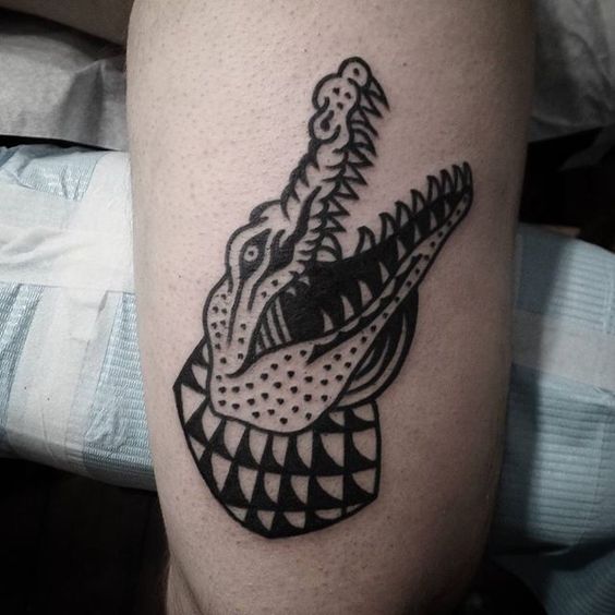 Tattoo of a colored crocodile on the thigh for men