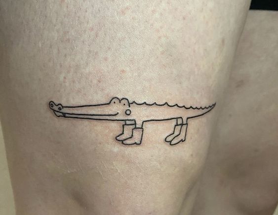 Crocodile tattoo on the thigh for women