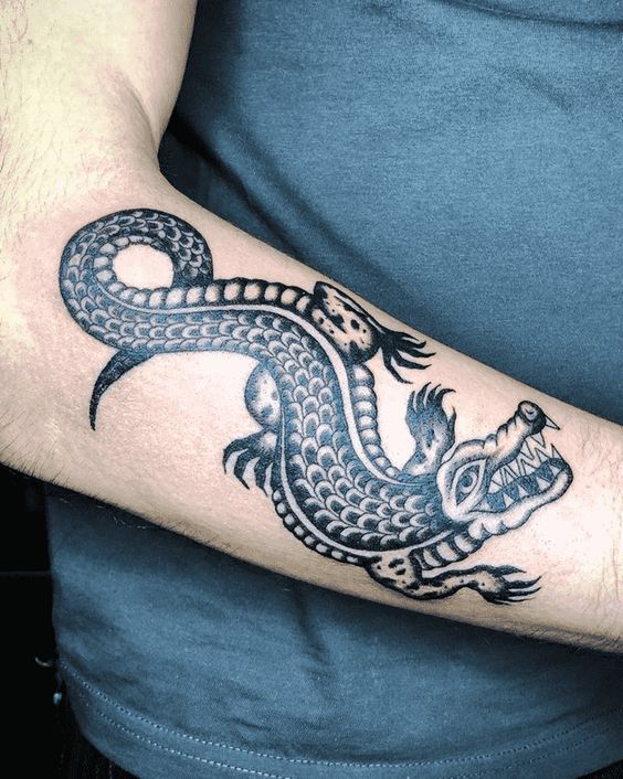 Tattoo of a crocodile on the forearm for men