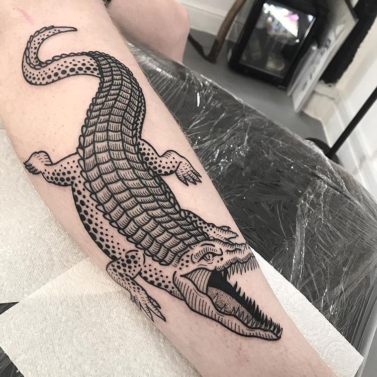 Crocodile tattoo on the shin for men