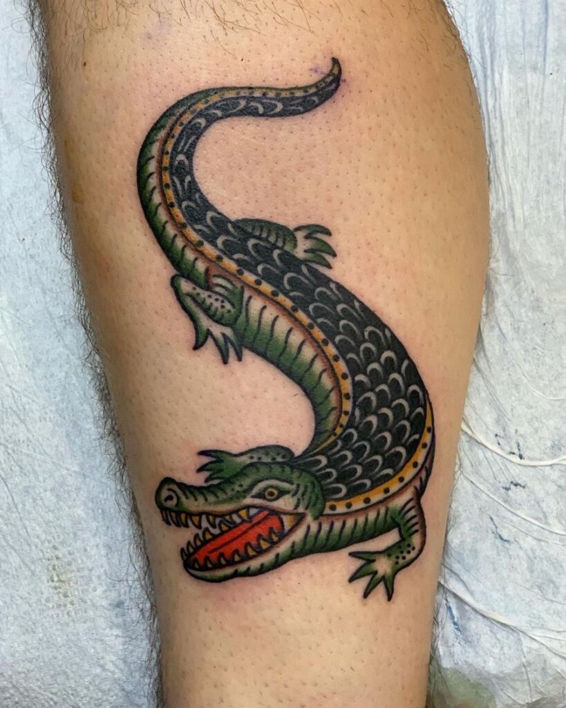 Crocodile tattoo on the shin for men