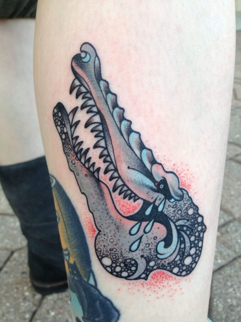 Crocodile tattoo on the shin for men