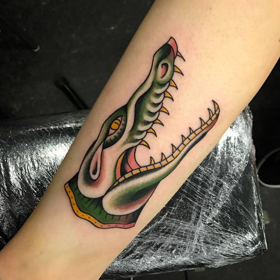 Tattoo of a crocodile on the forearm for men