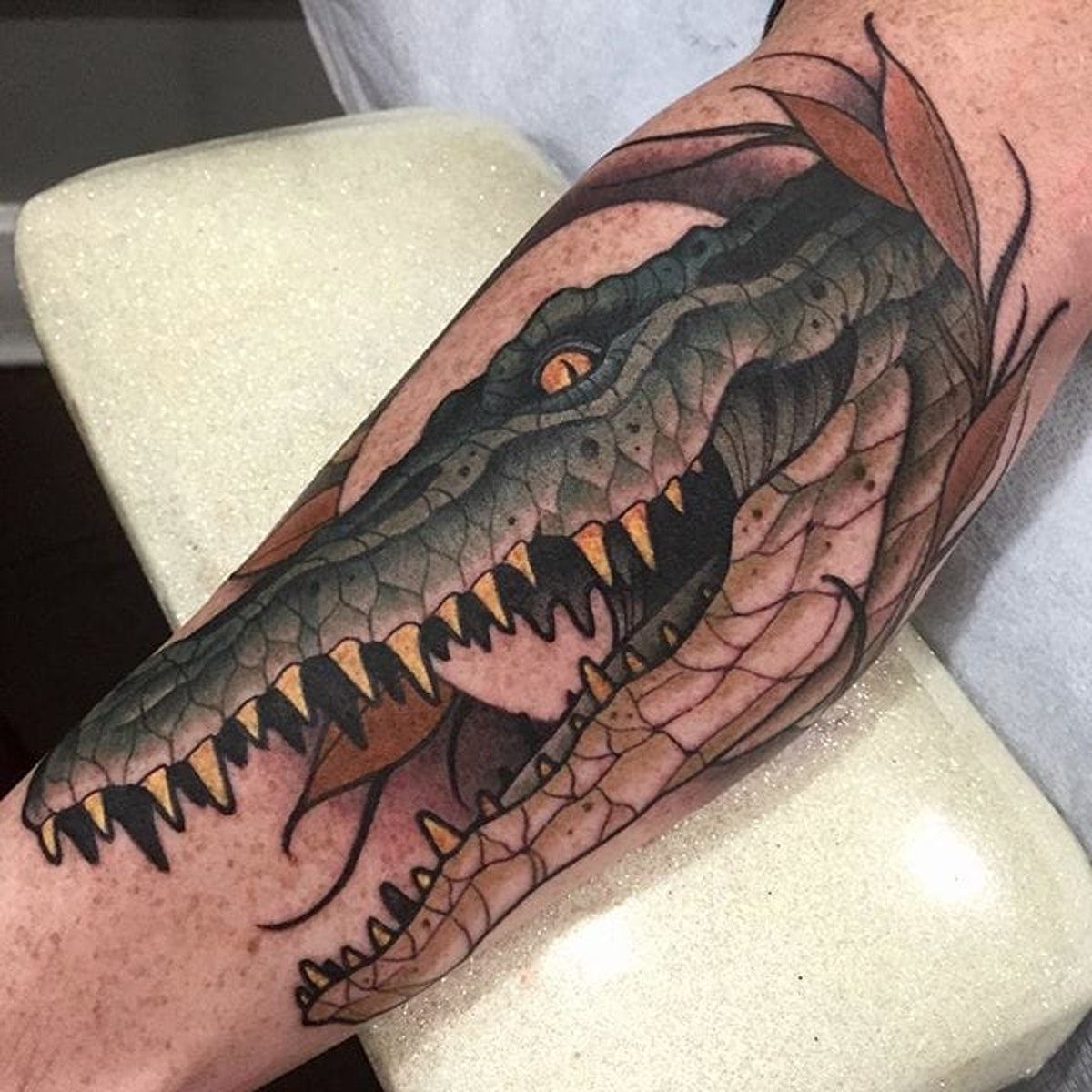 Tattoo of a crocodile on the forearm for men