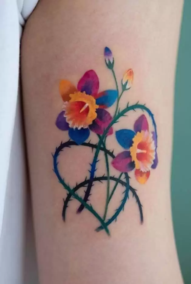 Daffodil flower tattoo on the shoulder for women