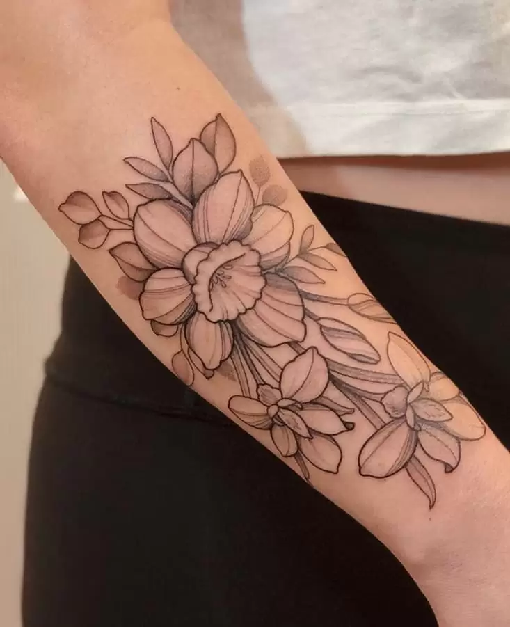 Daffodil flower tattoo on the forearm for women