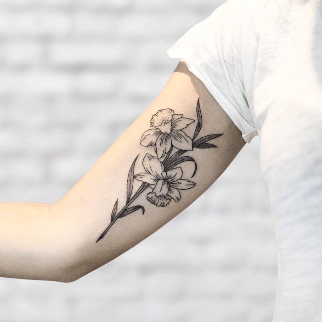 Daffodil flower tattoo on the shoulder for women