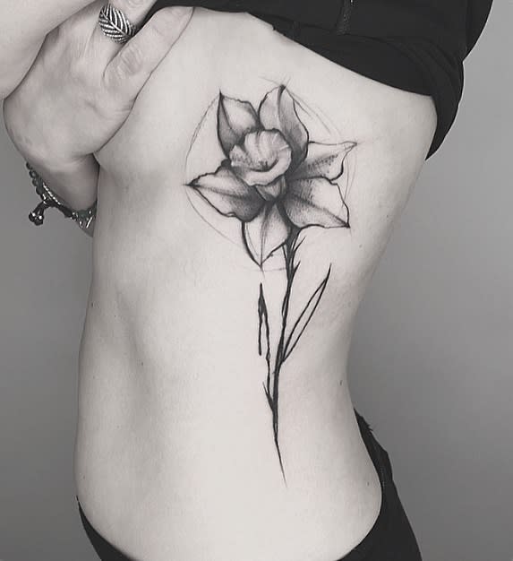 Large daffodil flower tattoo on the side for women