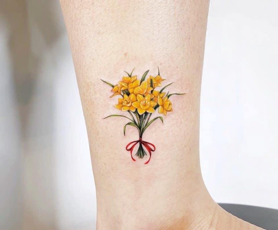 Daffodil flower tattoo on the shin for women