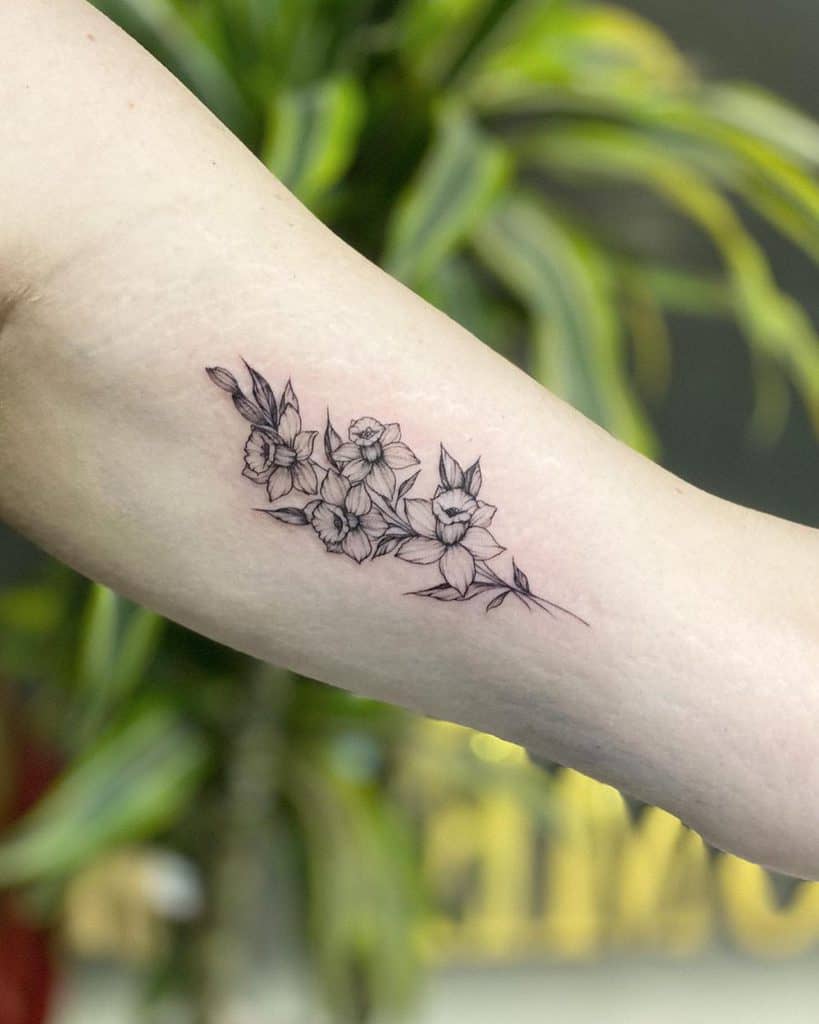 Daffodil flower tattoo on the forearm for women