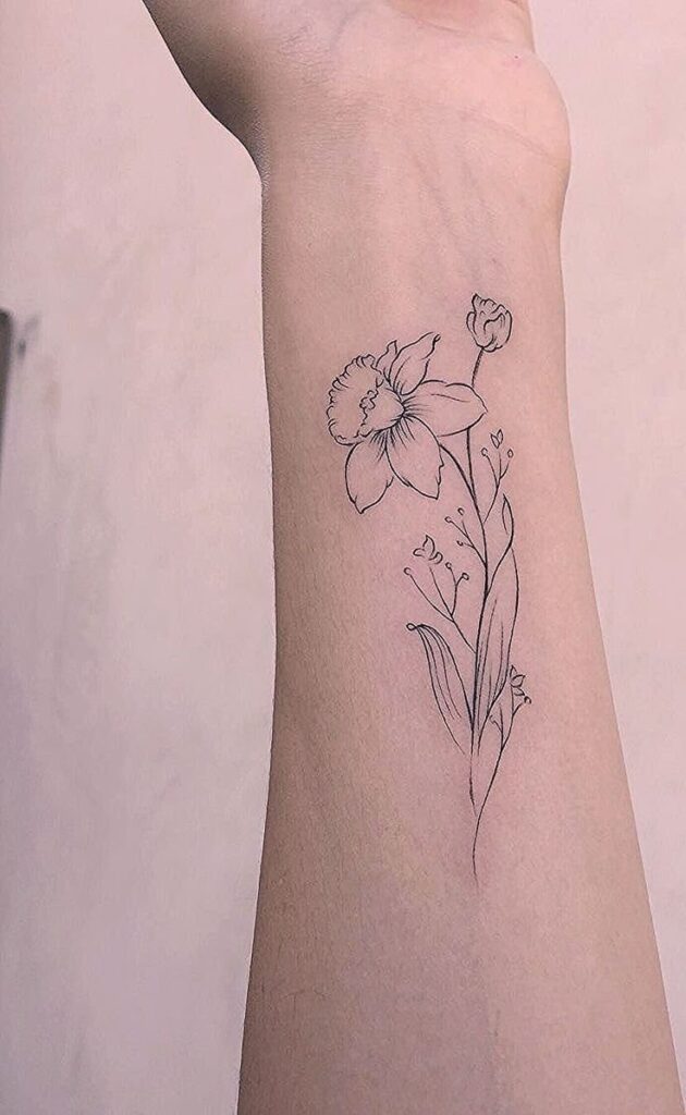 Daffodil flower tattoo on the forearm for women