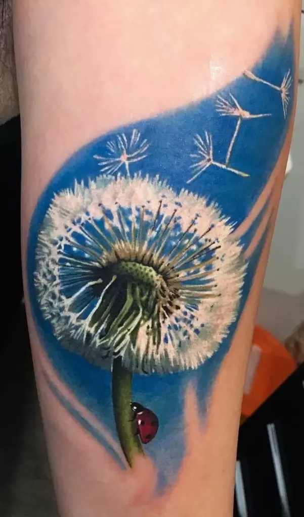 Large dandelion tattoo with ladybug on shin for women