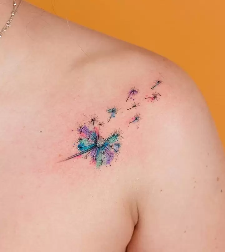 Colored dandelion tattoo on the collarbone for women