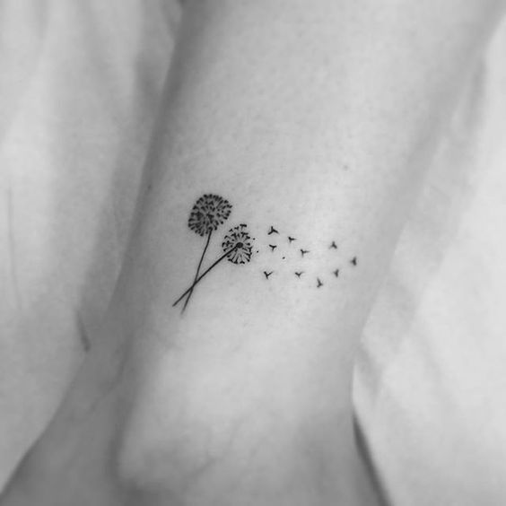 Small dandelion tattoo on the shin for women