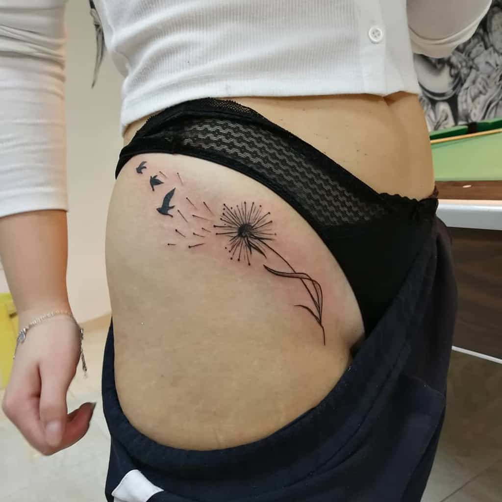 Large dandelion tattoo on the thigh for women