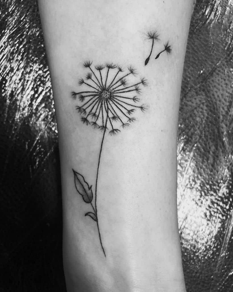 Large dandelion tattoo on the arm for women