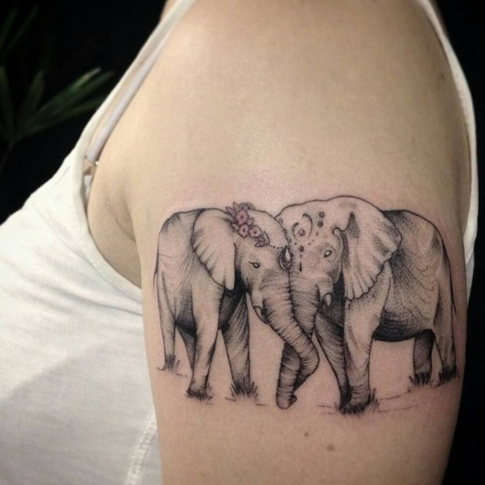 Tattoo of two elephants on the shoulder for women