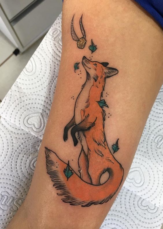 Tattoo of a colored fox on the shoulder for women