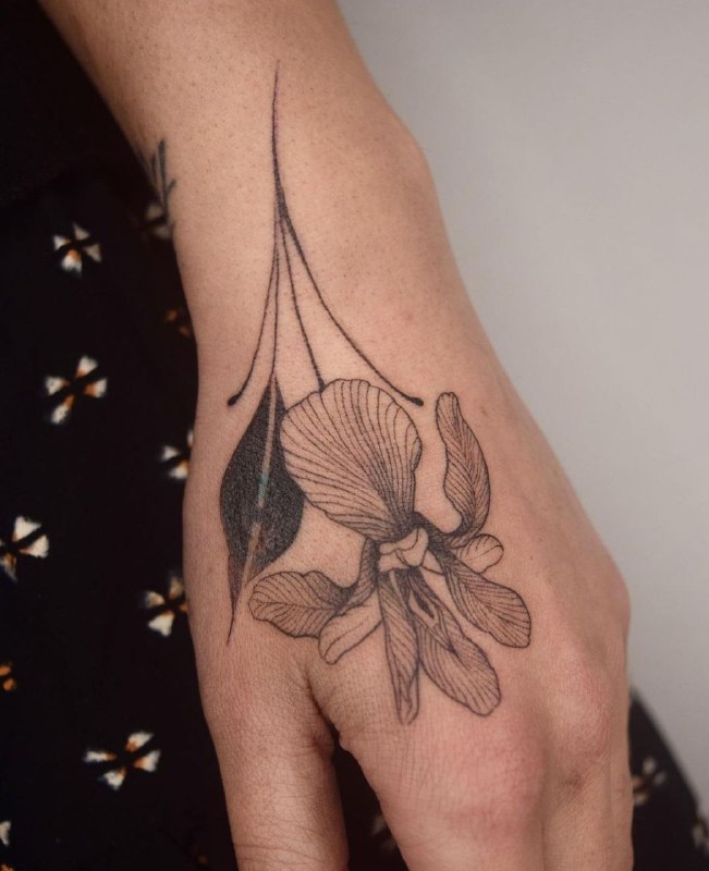 Iris tattoo on the hand for women