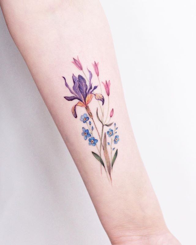 Color iris tattoo on the forearm for women