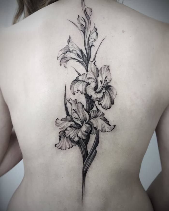 Iris tattoo on the spine for women