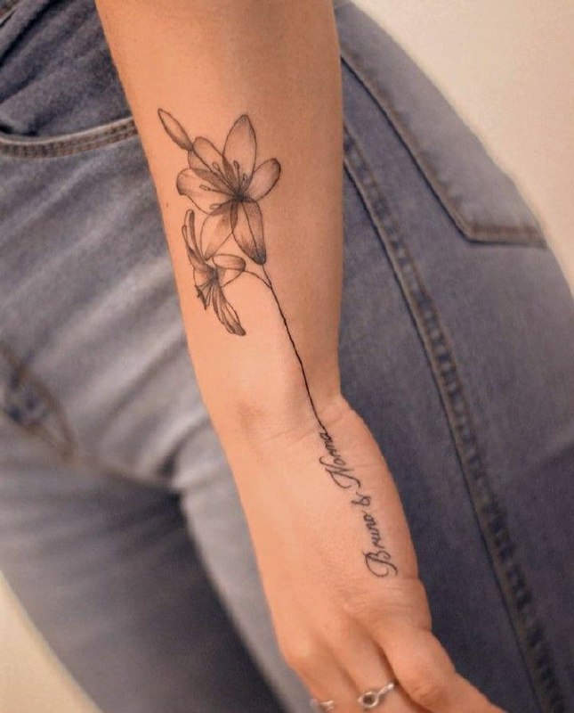 Jasmine tattoo with an inscription on the arm for women