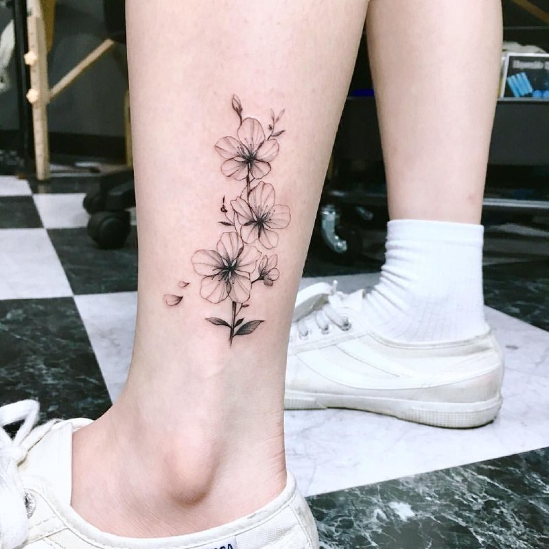 Jasmine tattoo on the shin for women