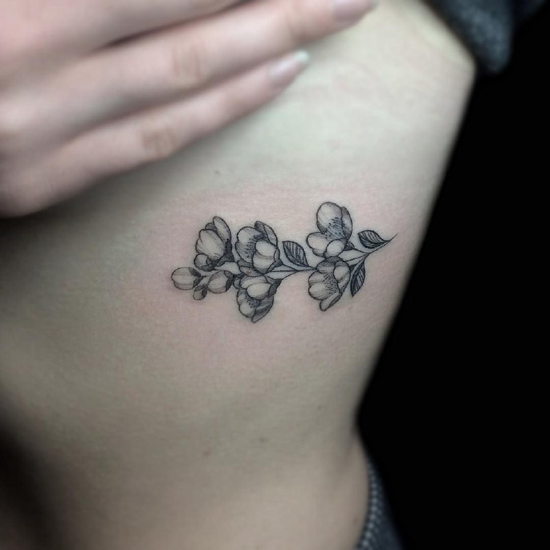 Jasmine tattoo on the side for women